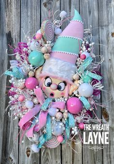 Ornament Christmas Wreath, Present Wreath, Pink Wreath, Lollipop Wreath, Christmas Pink Decor, Pastel Christmas Wreath Welcome the Christmas spirit with this whimsical elf wreath.  Two whimsical lollipops, a variety of ornaments (some are custom) whimsical white sprays, designer sequin ribbon and more! Approximately, 37 inches by 26 inches. Ships out within 1 to 3 business days! Thanks for shopping at The Wreath Layne. All items are shipped UPS or FedEx Ground shipping to the contiguous US only. Pastel Wreath Christmas, Candy Land Christmas Wreath, Candy Theme Wreath, Pink Candy Christmas Wreath, Christmas Candy Wreath, Christmas Wreath Pink, Pink Christmas Wreaths & Garlands, Pink Christmas Wreath, Elf Wreath