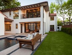 a large white house with a pool in the front yard