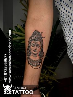 a woman's arm with a tattoo on it that has an image of a buddha