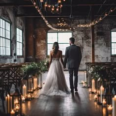 a bride and groom are walking down the aisle at their wedding ceremony in an industrial building