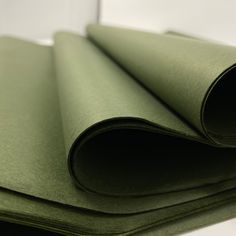 rolled up sheets of green paper on top of each other