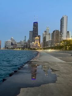 the city skyline is reflected in the water