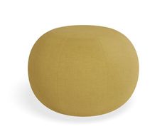 a round yellow ottoman sitting on top of a white floor