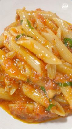 pasta with tomato sauce and parmesan cheese on a white plate