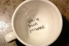 a white coffee cup with writing on the inside saying you're been prisoned