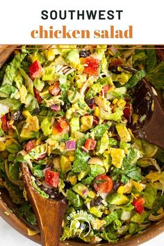 a salad with chicken and lettuce is shown in a wooden bowl on a white surface