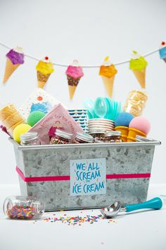 an ice cream bucket filled with lots of different types of treats and confetti