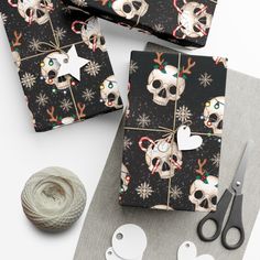 the wrapping paper is decorated with skulls and snowflakes