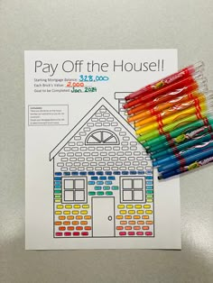 some colored pencils are sitting on top of a paper with the words pay off the house