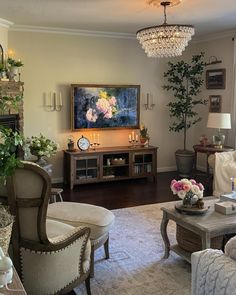 a living room filled with furniture and a chandelier