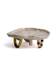 an animal print table with two legs on each side and one foot in the middle