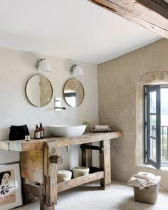 a bathroom with two sinks and mirrors on the wall next to a window that is open