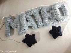 the word mate spelled out in crochet with two little black stars on it