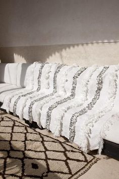 a row of white pillows sitting on top of a bed