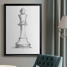 a black and white drawing of a chess piece hangs on the wall next to a blue chair