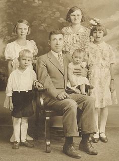 an old black and white photo of a family