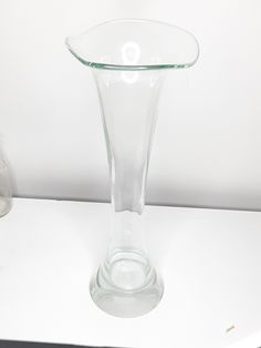 a glass vase sitting on top of a white table