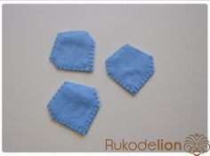 three pieces of blue felt sitting next to each other on a white surface with the words rukodelion written below it