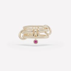 The Piera linked ring is comprised of three linked bands and features a trio of annulets with a central drop charm. Each ring in either 18k gold or .925 sterling silver is paired with a bezel-set stone in striking contrast and tactile appeal. Each Piera linked ring is individually handmade in Los Angeles.