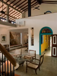 a living room filled with furniture next to a staircase