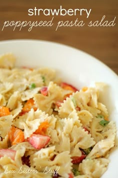 a bowl filled with pasta salad on top of a wooden table