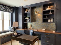 a home office with built in cabinets and desks, along with a window seat