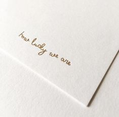 a close up of a piece of white paper with gold lettering on it that says, her lucky are one