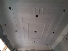 an unfinished room with white paint on the ceiling and some holes in the wall that are missing