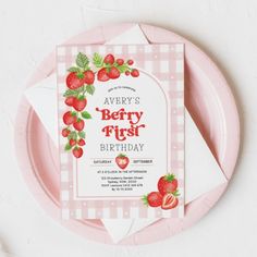 a strawberry themed birthday party with pink plates and napkins on the plate is shown