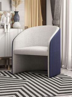 a white chair sitting on top of a black and white rug