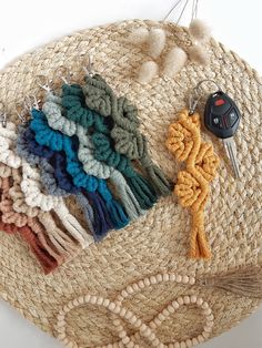 a straw hat with several different types of tassels on it and a keychain