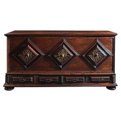 an old wooden chest with ornate carvings on the front and sides, against a white background