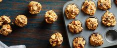 a muffin tin filled with baked goods on top of a wooden table