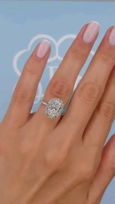 a woman's hand with a diamond ring on it