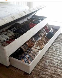 a bed with two drawers that have shoes in them on the bottom and bottom shelves