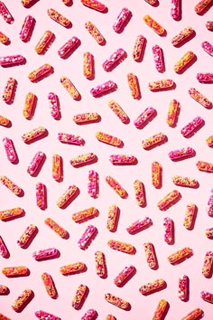 pink and orange sprinkled donuts on a pink background