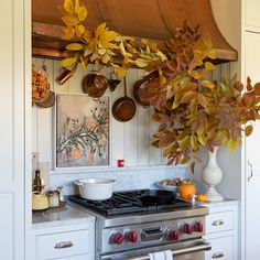 a stove top oven sitting inside of a kitchen next to a pot and pans