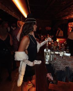 a woman in a costume standing at a bar