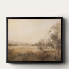 a painting hanging on the wall next to a white wall with a black framed frame