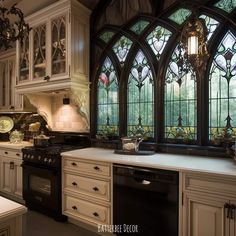 a kitchen with an oven, sink and stained glass windows in the wall above it