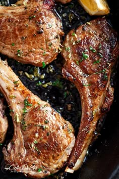 some meat is cooking in a skillet with black beans and parsley on top