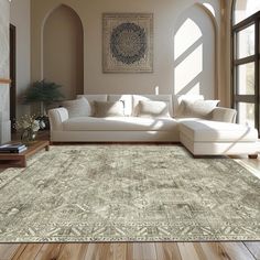 a living room filled with furniture and a large rug on top of a hard wood floor