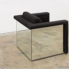 a black chair sitting on top of a cement floor