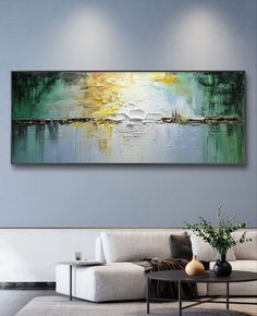 an abstract painting hangs on the wall above a couch