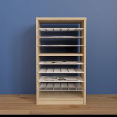 an empty shelf in a room with blue walls and wooden flooring on the side