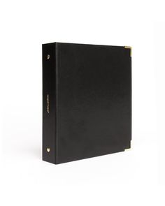 a black binder with gold trimmings on the front and bottom, sitting against a white background