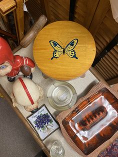 a table topped with lots of items like a baseball helmet and other things on it