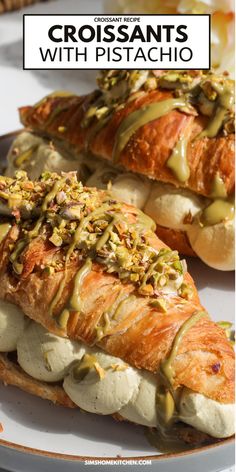 two croissants with pistachio sauce on them are sitting on a plate