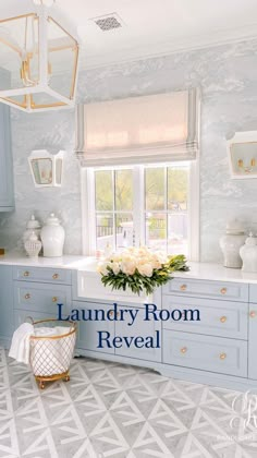 a kitchen with blue cabinets and white flowers