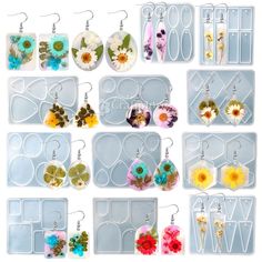 various earrings and earring sets displayed in plastic trays on white background with clipping for text